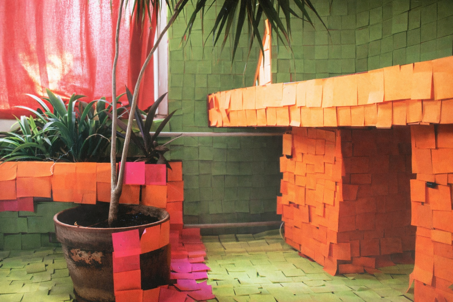 A room covered in colorful Post-it notes — green, orange, and pink.